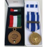 An original Kuwait Liberation and a NATO ISAF medals in their boxes.