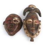 Two African carved wooden wall masks, 16.5cms (10.5ins) and 42cm (16.5ins) high.