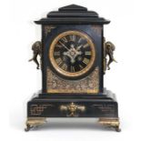 A Victorian black slate mantel clock, the black enamel dial with Roman numerals, the case