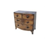 An early 19th century mahogany bowfronted chest of two short and two long graduated drawers, on