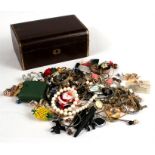 A quantity of costume jewellery and watches in a red leather jewellery box.