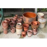 A large quantity of terracotta garden plant pots and other items.