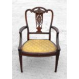 An Edwardian inlaid armchair with pierced splat and upholstered seat, on square tapering legs.