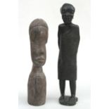 An African carved hardwood figure in the form of a stooped man, 25cm (9.75ins) high; together with