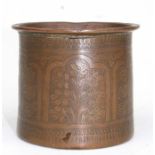 A Persian copper brush pot decorated with flowers and foliate, 8.5cm (3.25ins) high.