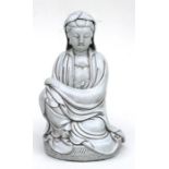A large Chinese glazed pottery figure depicting a seated Guanyin, 33cm (13ins) high.