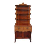 A late 19th century Arts & Crafts mahogany bookcase on stand, the three-tier open shaped book case