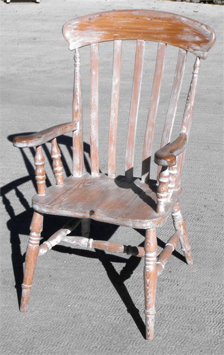 A stripped pine Windsor elbow chair.