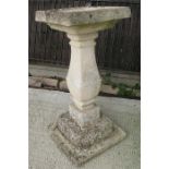 A weathered square section stoneware bird bath, 87.5cm (34.5ins) high.