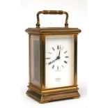 A brass cased carriage time piece clock, the enamel dial with Roman numerals, signed 'St James' to
