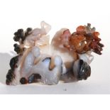 A Chinese carved agate group depicting two figures playing Go beneath trees, 14 by 9cm (5.5 by 3.