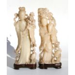 Two Chinese figural soapstone carvings on stands, depicting robed ladies with flowers, 33cm (