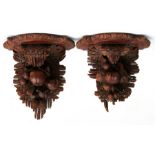 A pair of Black Forest wall brackets with carved fruit decoration (2).