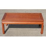 A Chinese hardwood kang or coffee table, standing on square legs, 96cm (38ins) wide.