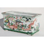 A 19th century Chinese famille rose planter decorated with figures in a ceremonial barge, 37 by 21