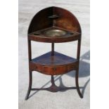 A Georgian mahogany corner wash stand with brass inset bowl, 60cm (23.5ins) wide.