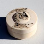 A Japanese Meiji period ivory box and cover decorated with tigers, 7cm (2.75ins) diameter. 61g