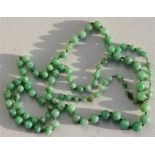 A graduated apple jade bead necklace, the largest bead 8mm diameter.