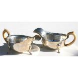 A pair of silver sauce boats with ivory handles, dated Sheffield 1936, 15.5cm (6ins) wide.