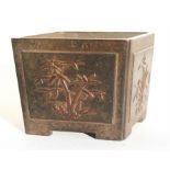 A Chinese bronze square form planter, decorated in relief with bamboo, prunus and flowers, impress