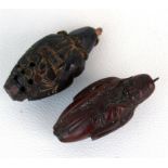 Two carved Heidao nuts in the form of bearded men, each 4cm (1.5ins) high.
