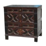 A Jacobean oak chest with geometric moulding, with four long drawers and brass drop handles,