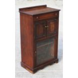 A late 19th century walnut side cabinet with a frieze drawer above a pair of cupboards, with