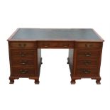 A reproduction yew wood pedestal partners desk, with green leather inset top above a combination