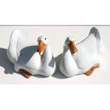 A pair of Chinese glazed ceramic pottery models of geese, 18cm (7ins) long.
