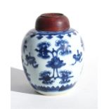 A Chinese blue & white ginger jar, decorated with flowers and fans, with pierced hardwood cover,
