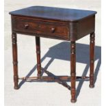 A 19th century mahogany side table with single frieze drawer, standing on ring turned legs joined by