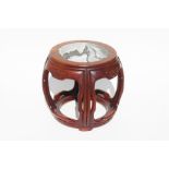 A Chinese hardwood drum table with inset figured marble top, 37cms wide.