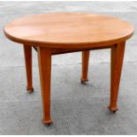 An early 20th century Arts & Crafts circular oak table, standing on square tapering legs, 106cm (