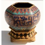 A Chinese cloisonne censer decorated with flowers on a turquoise ground, standing on a gilded
