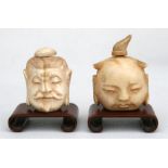 An early 20th century Chinese ivory snuff bottle on stand, in the form of a head, 5cm (2ins) high;