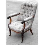 A William IV mahogany button back library chair, on turned front supports.