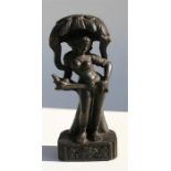 An Indian Schist stone carving, possibly Parvati standing under a tree, 30cm (12ins) high.