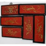 Six Chinese lacquered hardwood panels, decorated with gilded vases and flowers on a red ground,