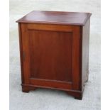 A late 19th century mahogany cupboard, the single door enclosing a shelved interior, standing on