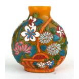 A Chinese Peking glass snuff bottle decorated with flowers on a yellow ground, in enamel colours and