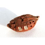 A Chinese carved Hediao nut in the form of a barge with hinged doors, 4cm (1.5ins) long.