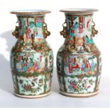 A pair of Chinese famille rose Canton Export vases, decorated with birds, insects, figures and