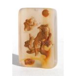 A Chinese rectangular carved agate pendent decorated with a bird and butterfly, 3.5 by 5cm (1.25