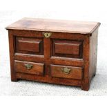 An 18th century Welsh oak coffer bach, the detachable rectangular top above two fielded panels, with