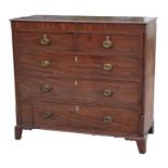 An early 19th century mahogany chest of two short and three long graduated drawers, with two
