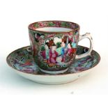 A Chinese Canton famille rose cup and saucer, decorated with figures, birds and flowers in enamel