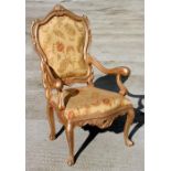 A modern gold painted French throne chair with upholstered seat and back.