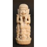 A late 19th century Indonesian ivory carving in the form of a demon, possibly a dagger handle,