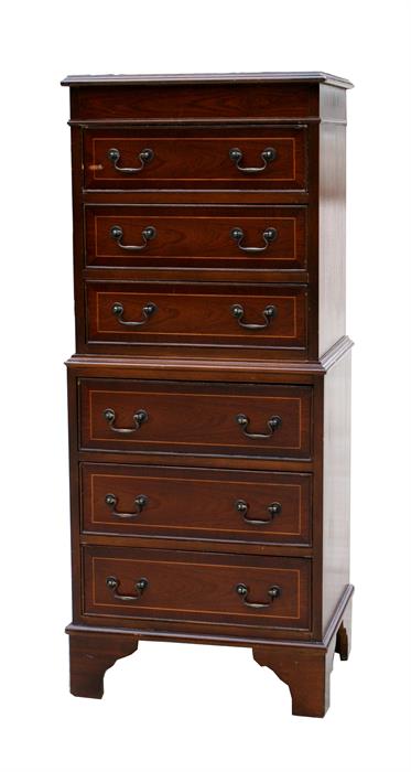 A reproduction mahogany chest on chest, with six long graduated drawers, standing on bracket feet,