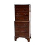 A reproduction mahogany chest on chest, with six long graduated drawers, standing on bracket feet,